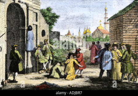 Cutting off the long robes of the Russian boyars under Tsar Peter the Great. Hand-colored halftone of an illustration Stock Photo