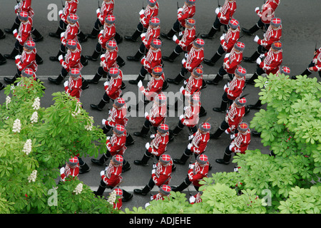 Guardsmen march in step at military parade column Officer Cadets marching symbol symbolism symbolic uniform arms gun rifle cap Stock Photo