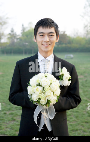 Wedding a bridegroom holding a bouquet Stock Photo
