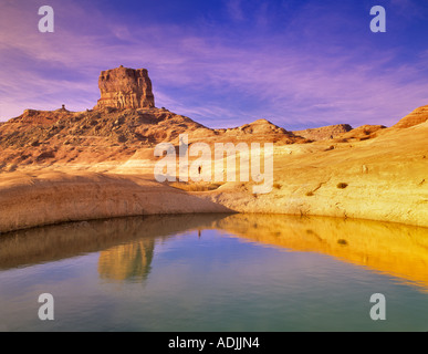 Hiker near reflection pool on banks of Lake Powell Utah Stock Photo