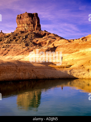 Hiker near reflection pool on banks of Lake Powell Utah Stock Photo