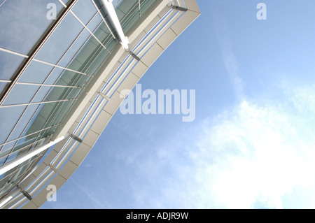 Looking up at the Eden Centre, High Wycombe against a hot blue sky with sun striking through white and pale blue clouds. Stock Photo