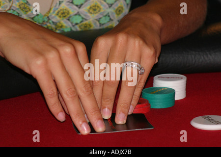 Female hands holding playing cards in poker game. Stock Photo