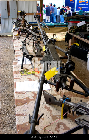 Vendor table featuring various machine guns and automatic weapons at a country gun show Stock Photo