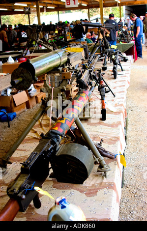 Vendor table featuring various machine guns and automatic weapons at a country gun show Stock Photo