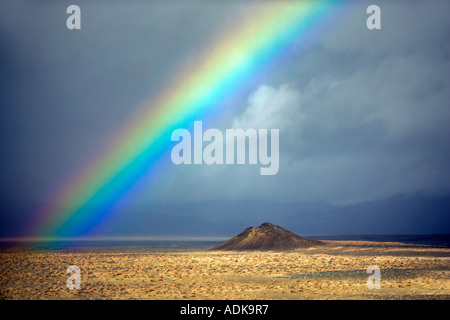 Small cinder cone and rainbow Black Rock Desert National Conservation Area Nevada Stock Photo