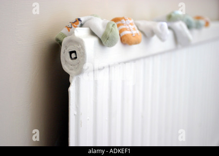 Baby Socks Drying on Radiator Stock Photo