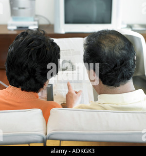 an old couple reading newspapers Stock Photo