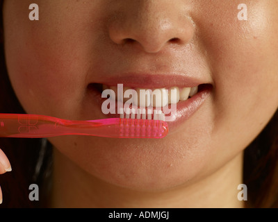 Woman brushing her teeth close up Stock Photo