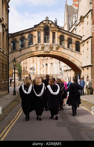 Three female graduates walking towards the Sheldonian Theatre under the bridge of Sighs, Oxford. Stock Photo