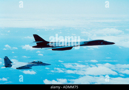 Side profile of a B-1B Lancer with another aircraft in flight Stock Photo