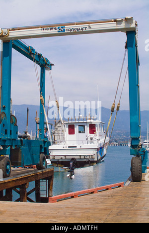 Yacht in dry dock being lifted by automated crane Stock Photo