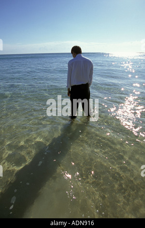 Businessman standing in sea Stock Photo