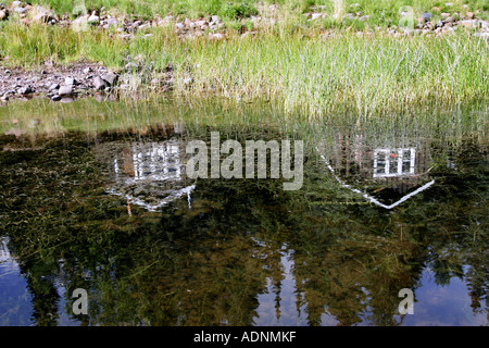 Lodge reflected in Babine lake in British Columbia, Canada Stock Photo