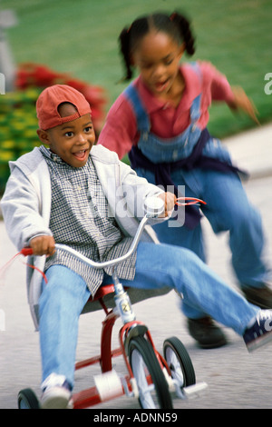 Boy riding tricycle hot sale