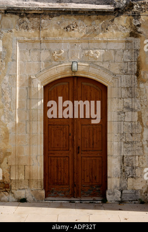 Wooden door in a stone wall texture Stock Photo
