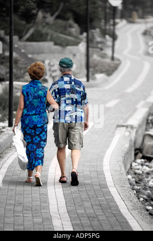 Senior couple walking away together Stock Photo
