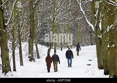 People walk across snow covered Hampstead Heath London United Kingdom Stock Photo