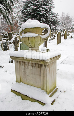 Snow covered monument of Hugh Gaitskell s grave Hampstead Parish churchyard London UK Stock Photo