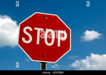 A North American Canadian Road Traffic Driving Highway Stop Sign Against A Blue Sky Background Stock Photo
