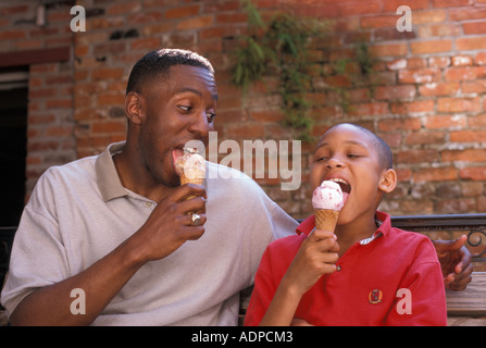 African American father and son eating ice cream cones Stock Photo