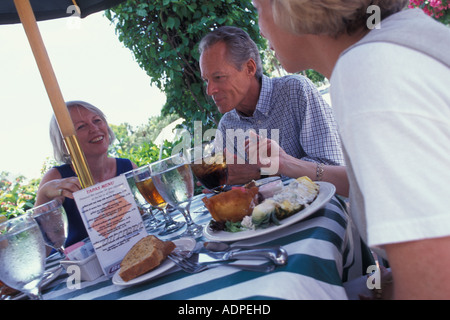 Caucasian seniors enjoying lunch in outdoor cafe Stock Photo