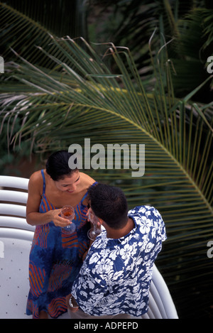 Latino couple enjoying wine on balcony Stock Photo
