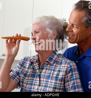 Senior Caucasian couple preparing meal in home kitchen Stock Photo