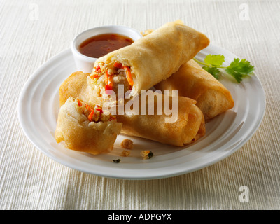 Oriental spring rolls filled with chicken, vegetables with a chilli dipping sauce Stock Photo