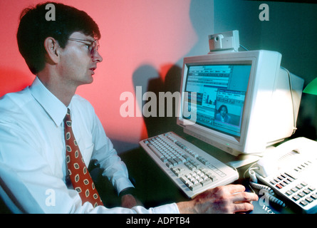 Basking Ridge, N J, U S Corp R & D Laboratory Man Working on Computer using Webcam Internet Businessman Looking at Screen, people looking at computer Stock Photo