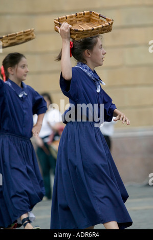 Young Basque girls dressed in blue perform a traditional Basque folk dance with baskets Plaza Arriaga Bilbao Stock Photo