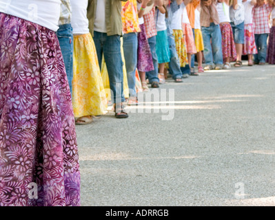 a cropped view of a row of children's legs Stock Photo