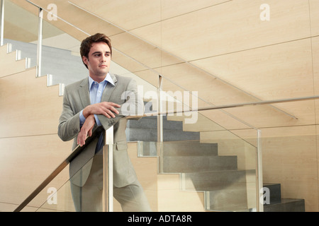 Businessman Standing on Stairs Stock Photo