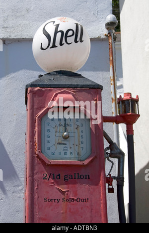 One time petrol filling station shows old Shell petrol pump displaying old prices two shillings one penny a gallon at St Mawes Cornwall England UK Stock Photo