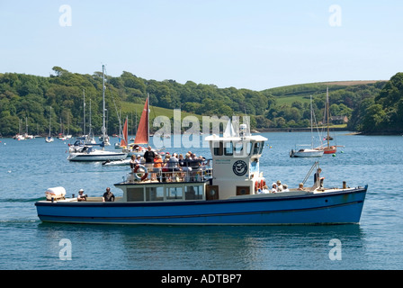 Off St Mawes pleasure tour boat with passengers approaching landing facilities Stock Photo