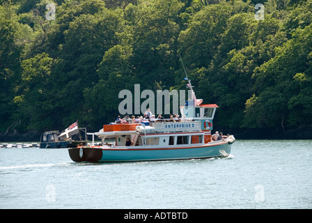 Trelissick river tour boat with passengers on Carrick Roads with woodland beyond Stock Photo