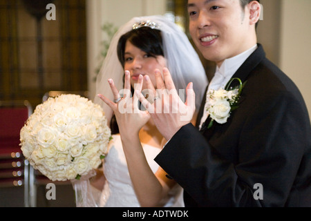 Bride and groom showing their wedding rings on their hands after wedding ceremony Stock Photo
