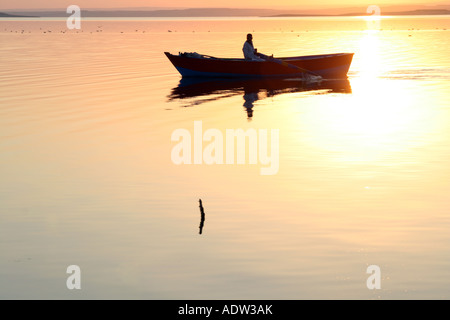 Magical Golden Sunset - Small Boat Stock Photo