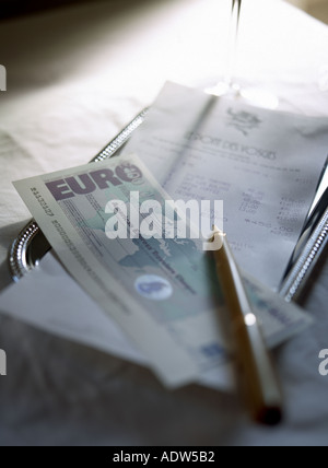 RESTAURANT'S TIP TRAY WITH TILL RECEIPT PEN AND EURO  TRAVELLERS CHEQUE Stock Photo