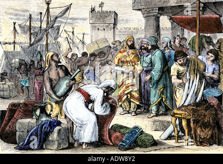 Ancient Phoenician sailors trading goods in a Mediterranean seaport. Hand-colored woodcut Stock Photo