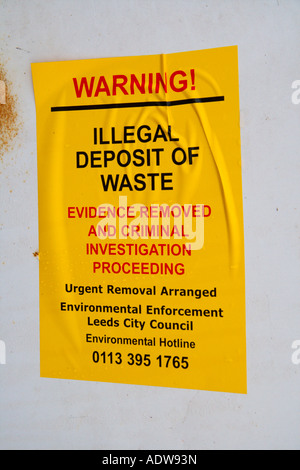 Police warning notice on an old abandoned fridge Illegal deposit of Waste Stock Photo