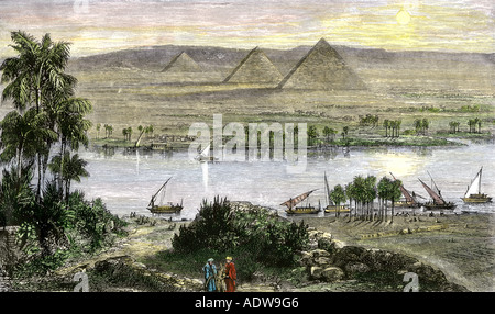 Pyramids at Gizeh with dhows on the Nile River. Hand-colored woodcut Stock Photo