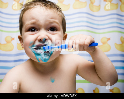 Boy brushing teeth in bathroom Stock Photo