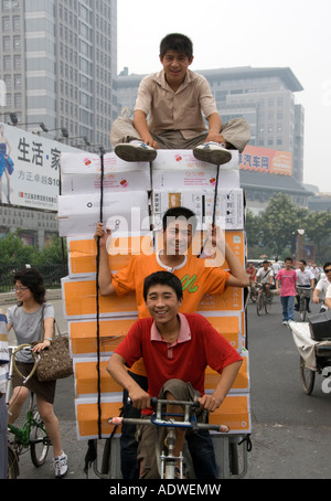 Men riding tricycle carrying many computers at Zhonguancun high technology district of Beijing 2007 Stock Photo