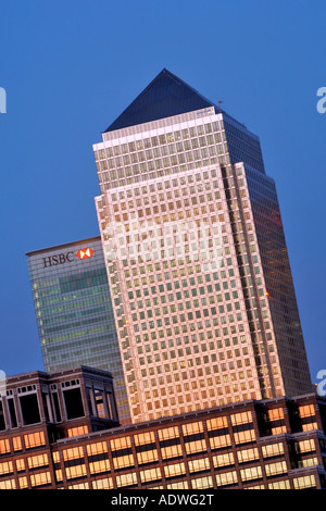 Oblique dusk view of Canary Wharf Tower and other buildings in the docklands on the Isle of Dogs in London. Stock Photo