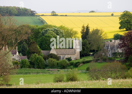 Asthall Manor House village and Church of St Nicholas in scene in The Cotswolds Oxfordshire United Kingdom Stock Photo
