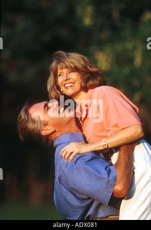 happy couple, man lifting woman Stock Photo