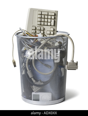 Waste paper basket with keyboard and computer cables Stock Photo