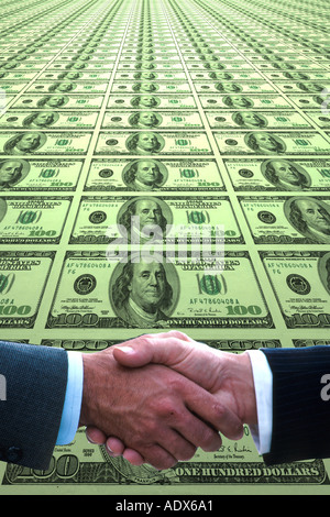 men shake hands on background of US dollars Stock Photo