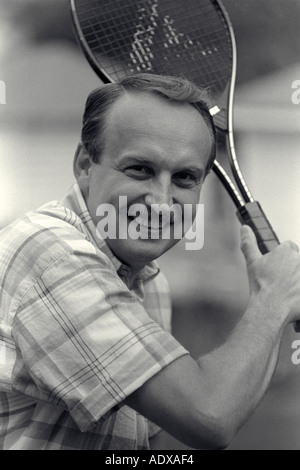 Mid age Man Playing Tennis Stock Photo